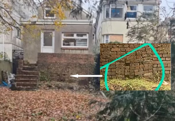 Rear wall with loose bricks where entrance was suspected